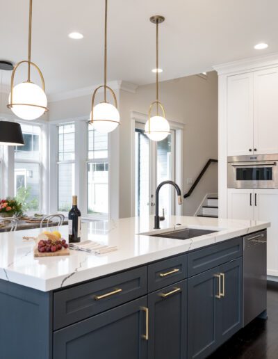 A kitchen with blue cabinets and stainless steel appliances.