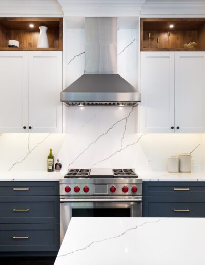 A kitchen with white cabinets and blue counter tops.