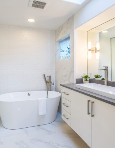 A modern bathroom with a glass shower and tub.