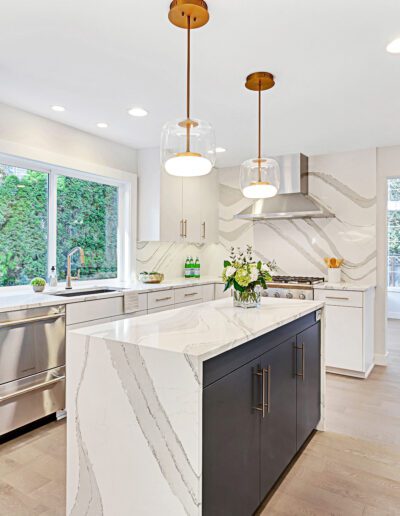 A white kitchen with stainless steel appliances.