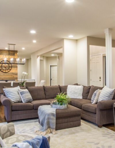 A living room with hardwood floors and a brown couch.