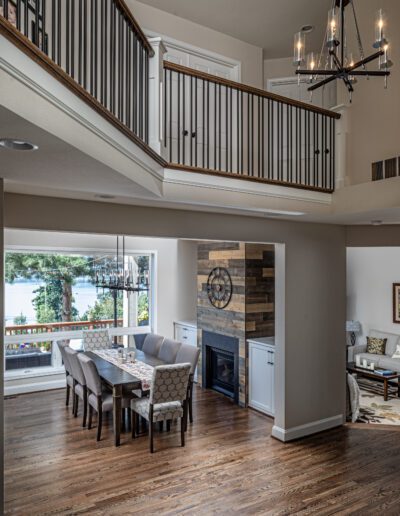 An open floor plan with hardwood floors and a staircase.