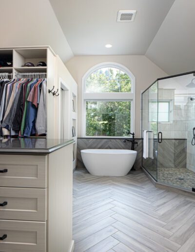 A large walk in closet with a tub.