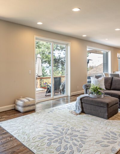 A living room with a couch and a large window.