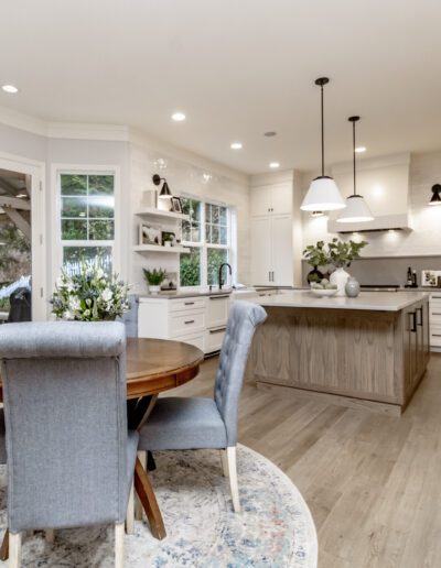 A kitchen with hardwood floors and a dining table.