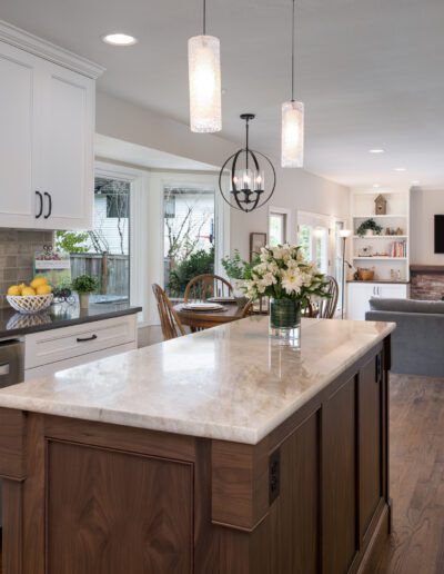 A kitchen with white cabinets and a center island.