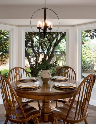 A dining room with a wooden table and chairs.