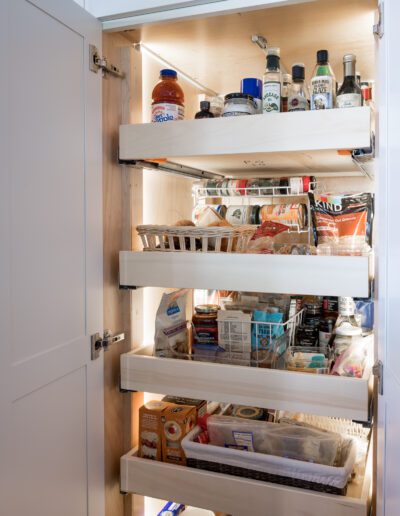 A kitchen with a lot of food in it.