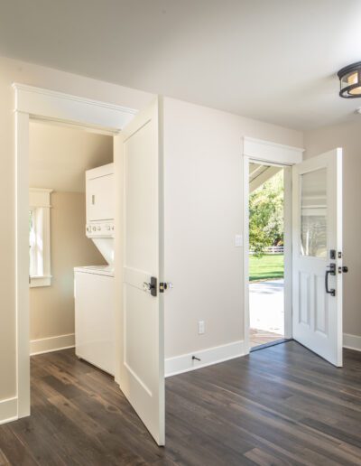 A room with white walls and hardwood floors.