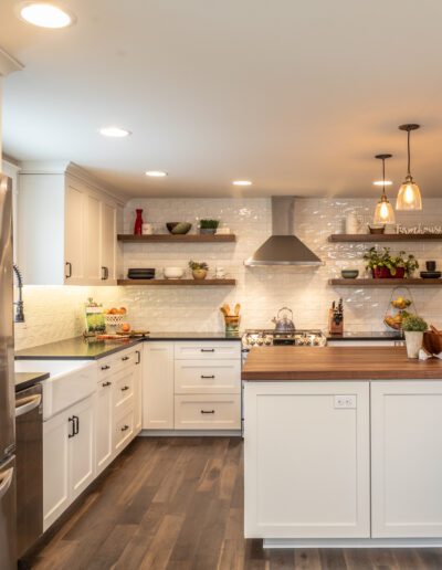 A kitchen with white cabinets and stainless steel appliances.