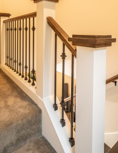 A stair railing in a home with wooden railings.