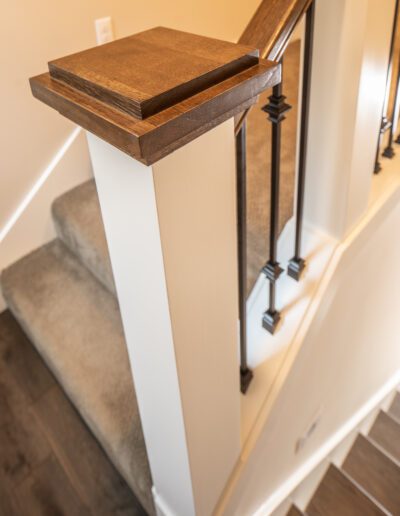 A stair railing with a wooden handrail.