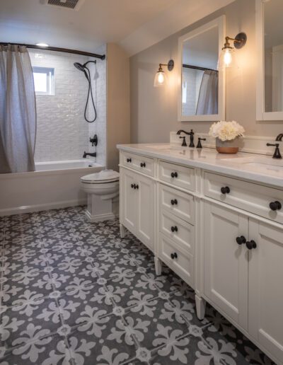 A white and gray bathroom with a tile floor.
