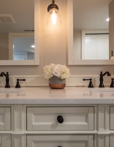 A bathroom with two sinks and two mirrors.