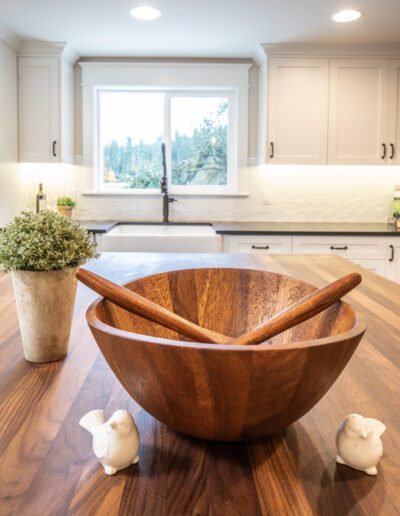 A wooden bowl on top of a kitchen counter.