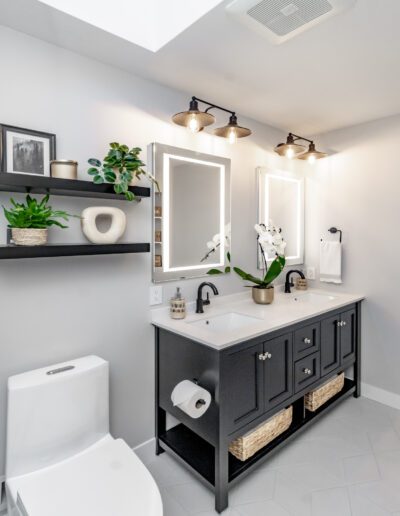 A black and white bathroom with a toilet and sink.