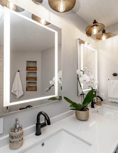 A bathroom with two sinks and a mirror.