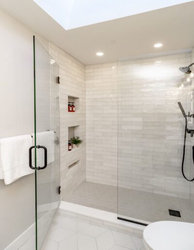 A white bathroom with a glass shower stall.