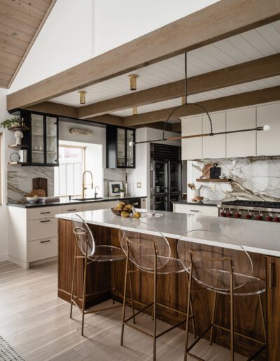 A modern kitchen with wooden beams and a center island.