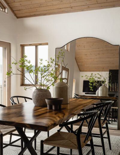 A dining room with a wooden table and chairs.