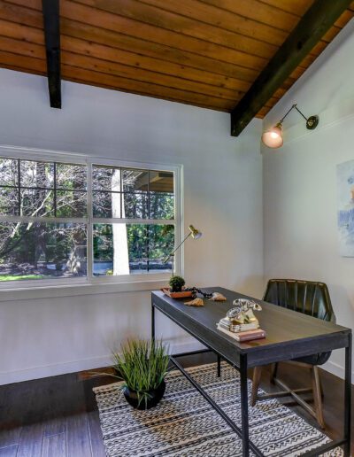 A home office with a desk and a window.