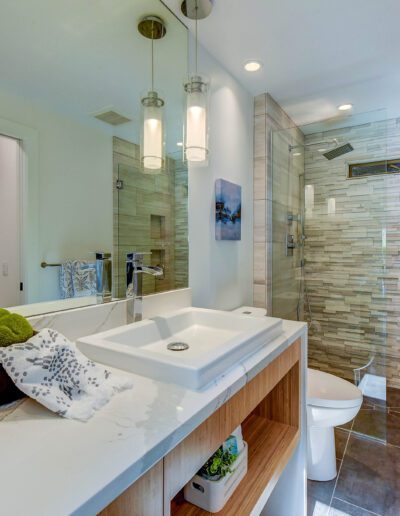 A modern bathroom with a glass shower and sink.