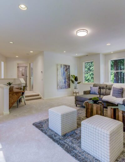 A large living room with a fireplace and large windows.